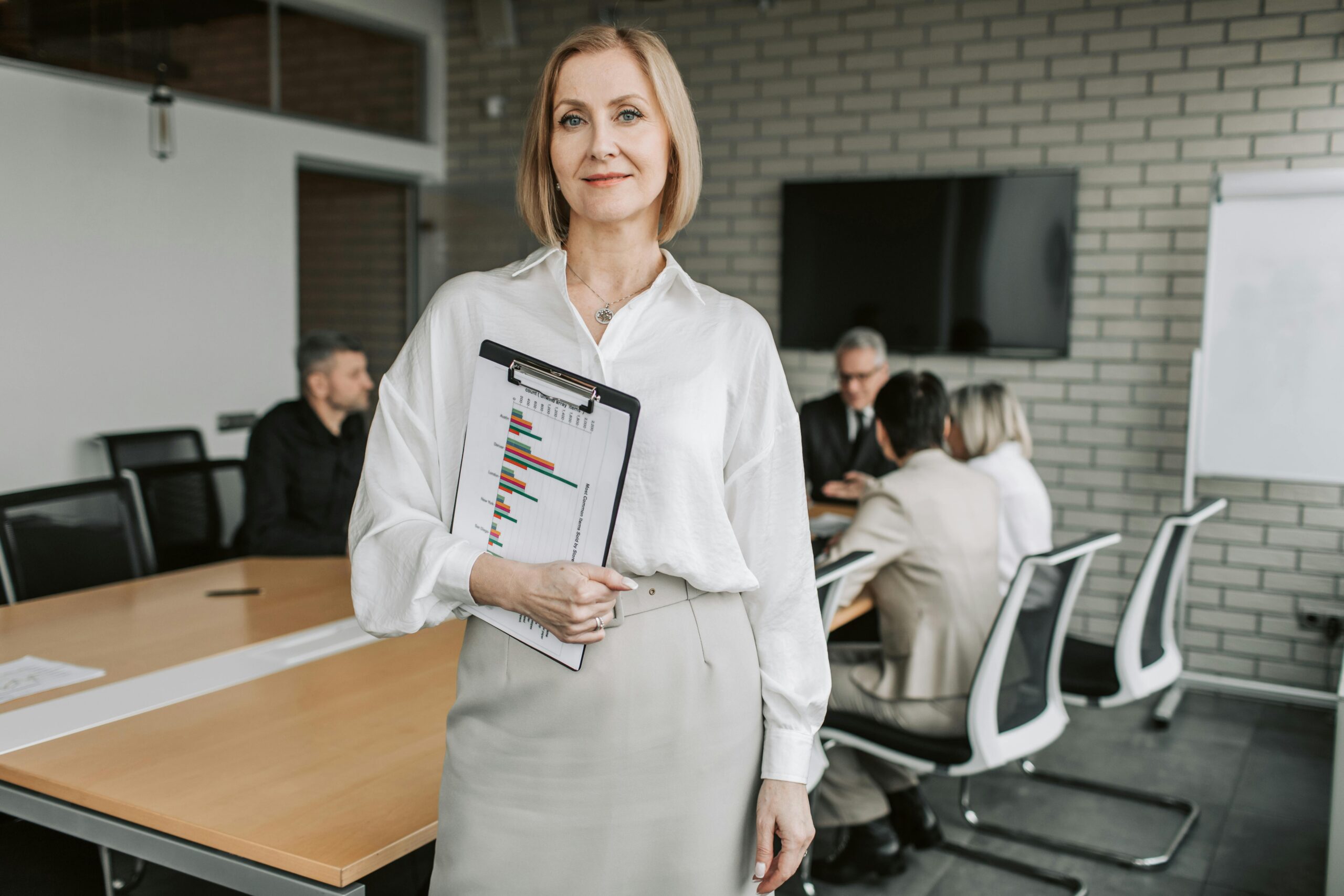 A woman carrying a clipboard.